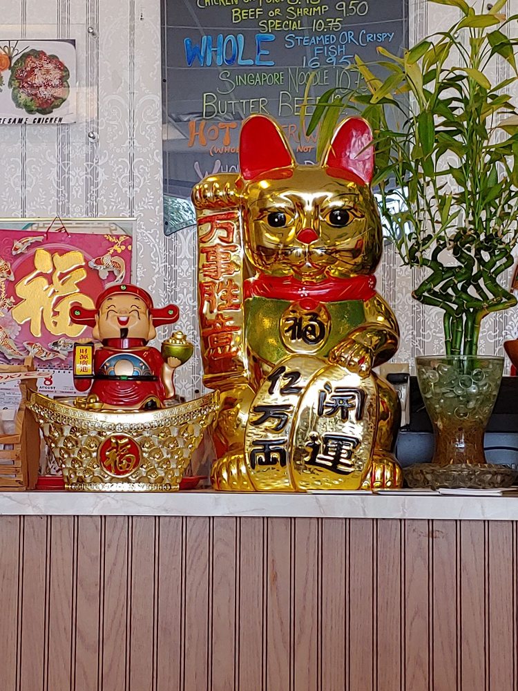 Gold lucky cat on the counter at Pho Happy Wok